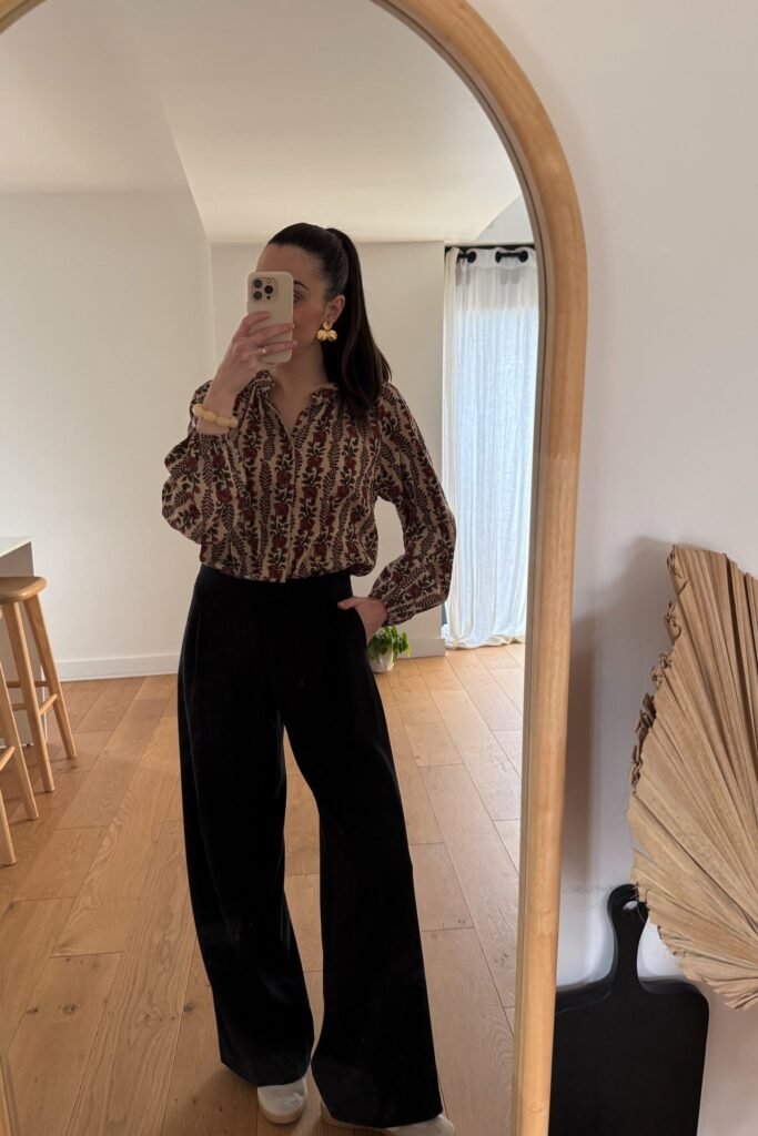 Red and Beige Floral Print Blouse + Black High-Waisted Wide-Leg Trousers + Beige Sneakers