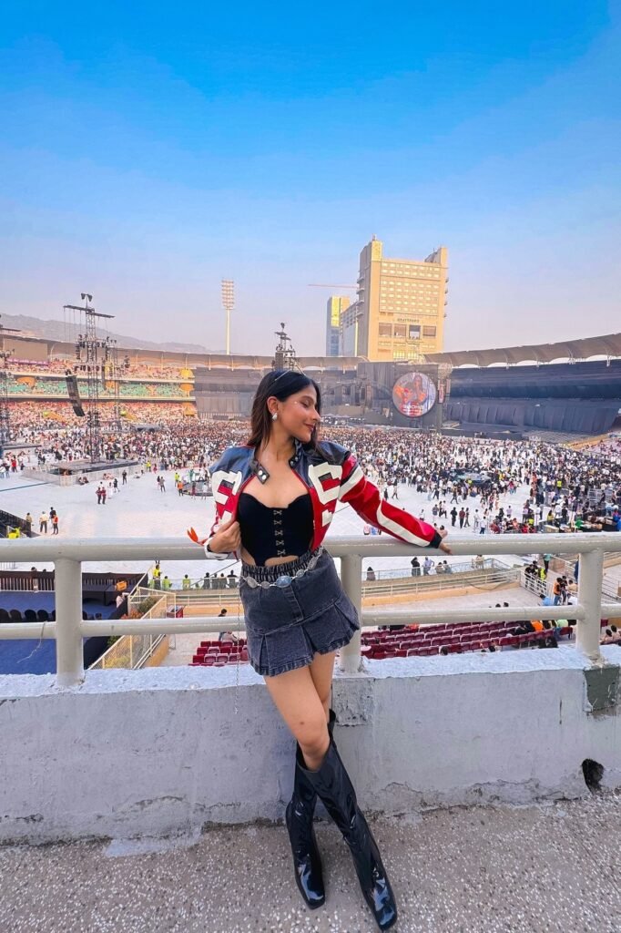 Red and Black Racing Jacket + Black Corset Top + Denim Pleated Skirt + Black Knee-High Boots