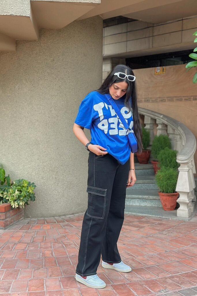 Royal Blue Graphic T-shirt + Black Contrast-Stitch Cargo Pants + White and Burgundy Sneakers