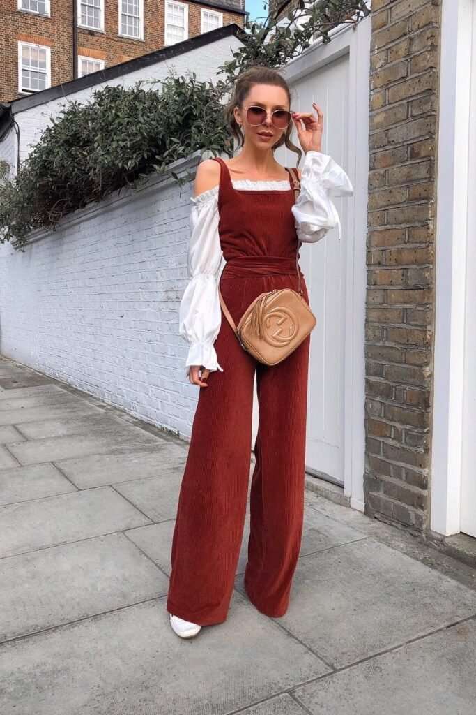 Rust Red Corduroy Overalls + White Off-the-Shoulder Puff-Sleeve Blouse + White Loafers