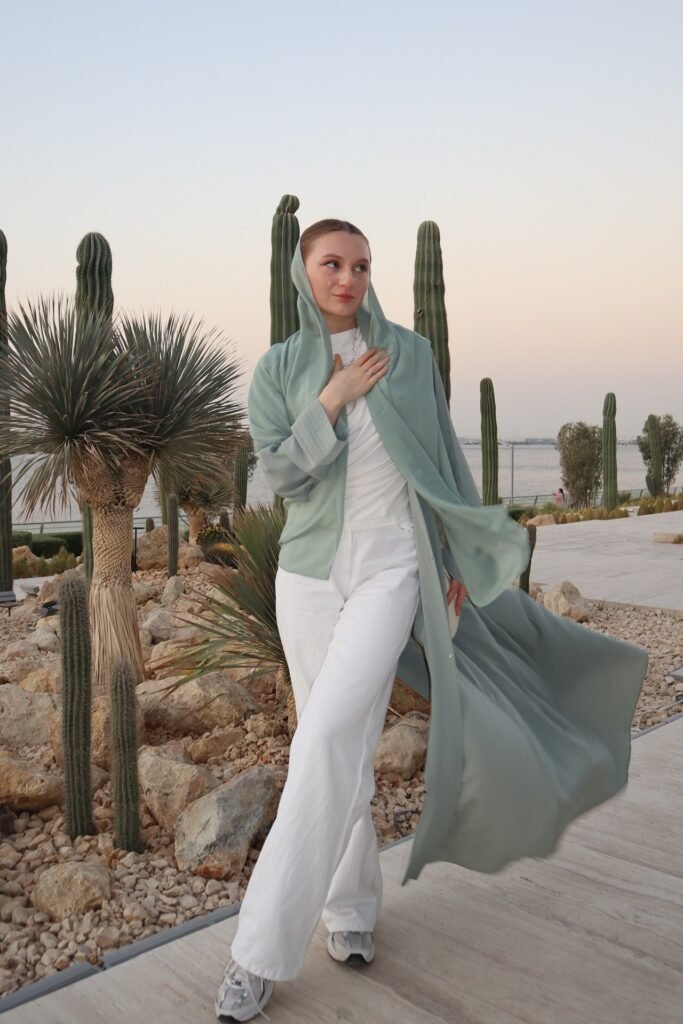 Sage Green Open Abaya + White Ribbed Top + White Wide-Leg Trousers + Grey Athletic Sneakers