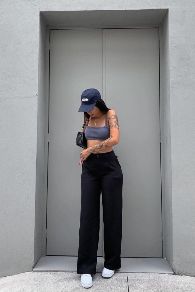 Slate Blue Sports Bra + High-Waisted Black Wide-Leg Trousers + Navy Baseball Cap + White Sneakers