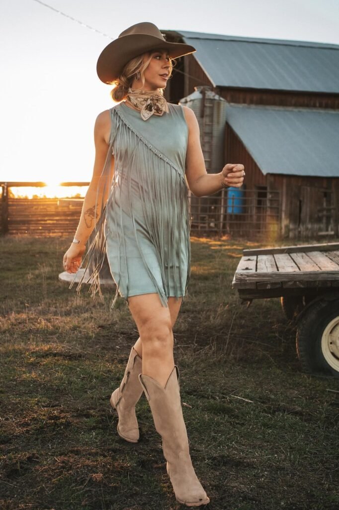 Sleeveless Sage Fringe Dress + Brown Cowboy Hat + Beige Suede Boots + Tan Patterned Neck Scarf