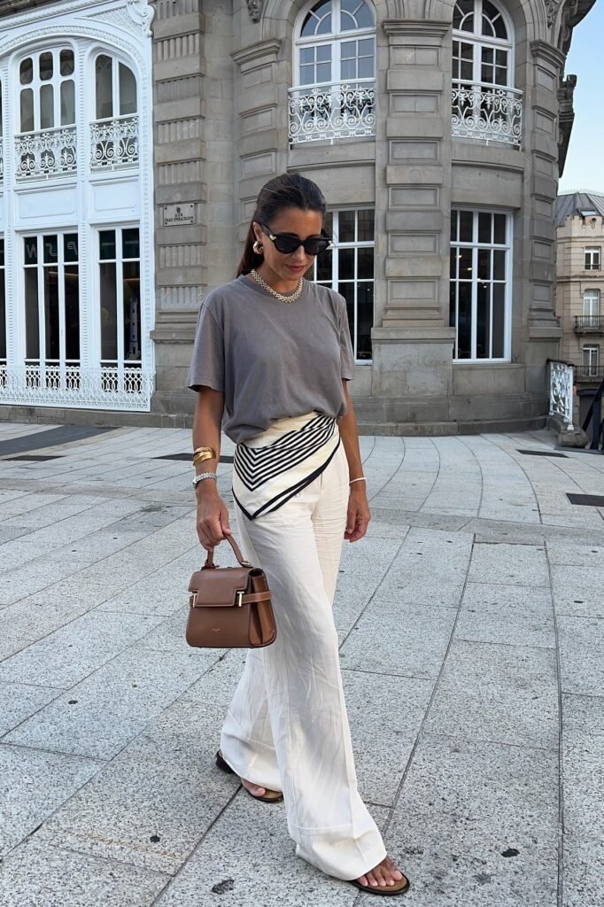 Striped Pointed Waist-Scarf + Grey Crewneck T-Shirt + White Linen Trousers + Brown Handbag