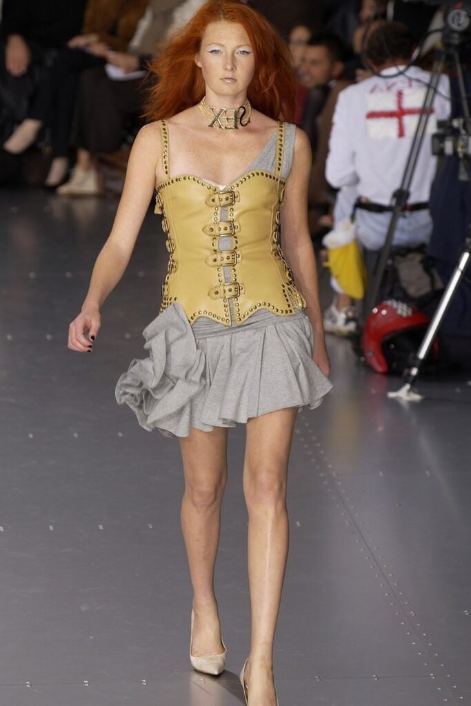 Tan Buckled Corset + Grey Ruffled Mini Skirt + Cream Pointed-Toe Heels