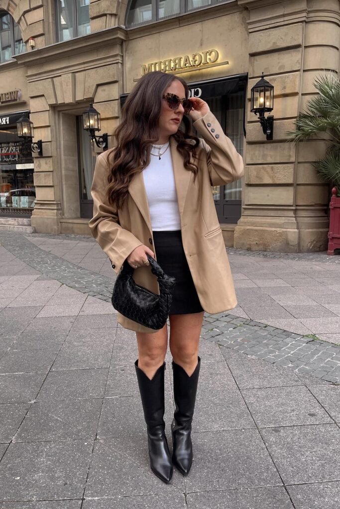 Tan Leather Oversized Blazer + White Ribbed Top + Black Mini Skirt + Black Pointed Cowboy Boots
