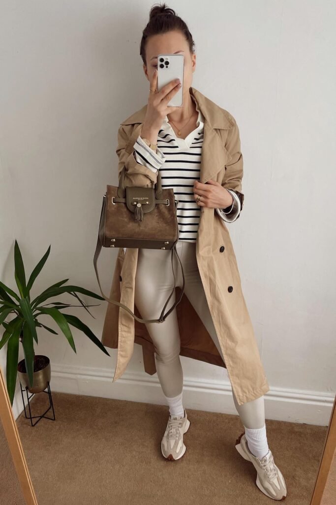 Tan Trench Coat + Black and White Striped Polo + Off-White Leggings + Beige Sneakers