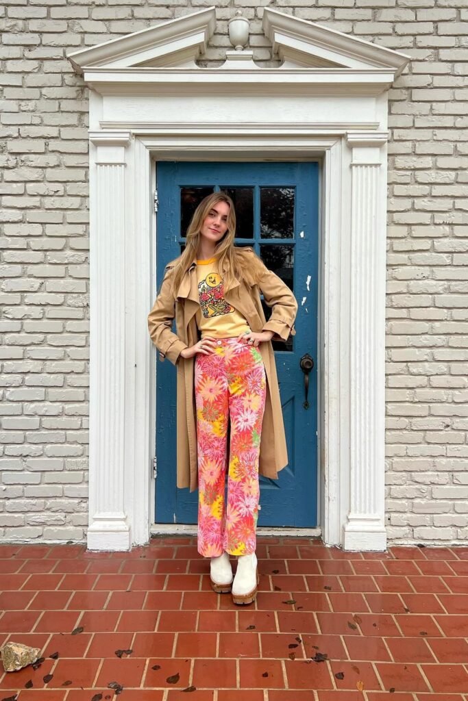 Tan Trench Coat + Graphic Yellow Tee + Pink Floral Straight-Leg Pants + White Platform Boots