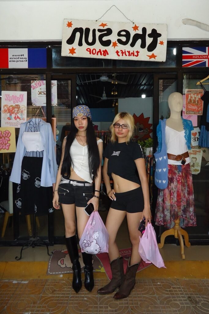  White Asymmetrical Tank + Black Micro Shorts + Knee-High Pointed Boots