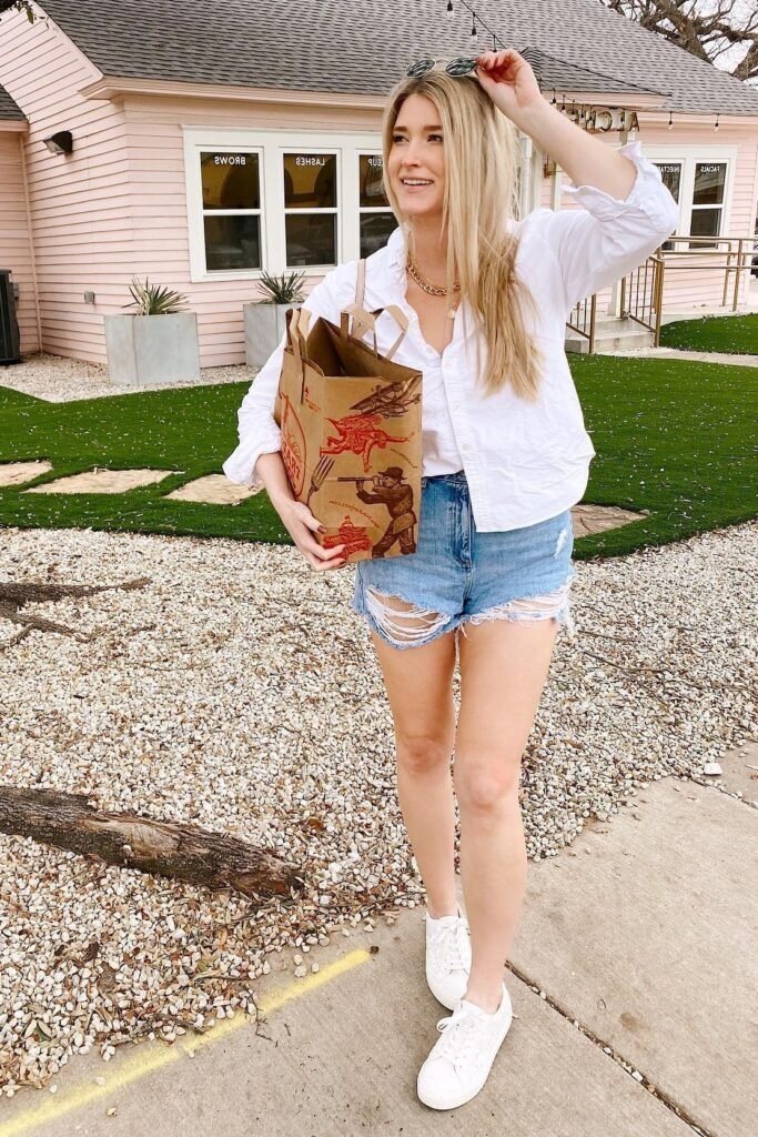 White Button-Down Shirt + Heavily Distressed Denim Shorts + White Sneakers