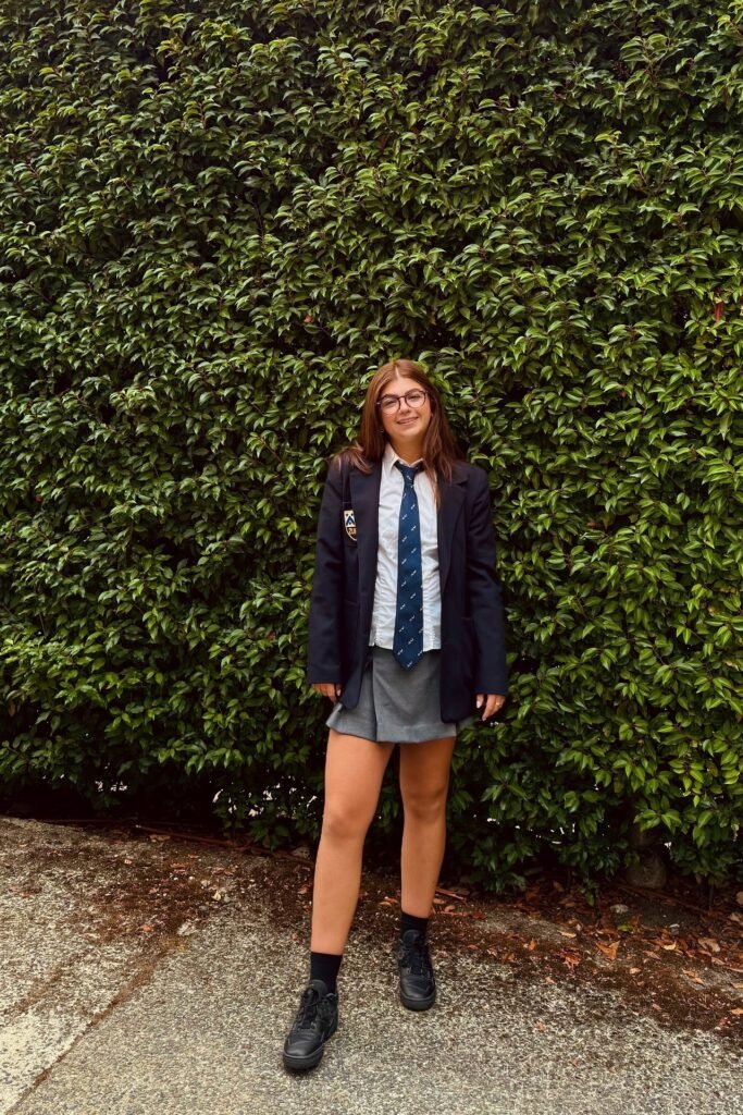 White Button-Down Shirt + Navy Necktie + Navy Blazer + Grey Pleated Mini Skirt + Black Socks + Black Sneakers