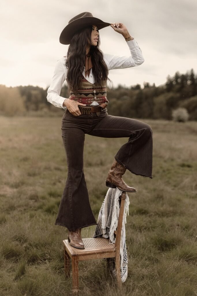 White Button-Down Shirt + Patterned Western Vest + Dark Brown Flared Jeans + Brown Leather Cowboy Boots + Dark Brown Cowboy Hat