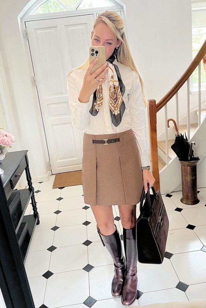 White Button-Down Shirt + Tan Pleated Mini Skirt + Brown Riding Boots