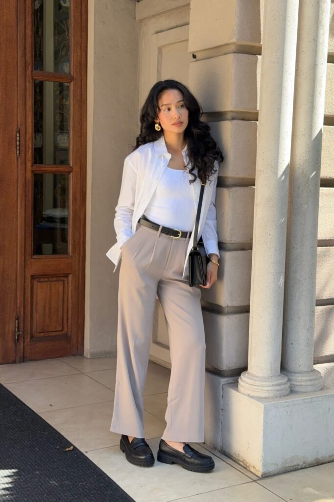 White Button-Up Shirt over White Ribbed Tank + Taupe Pleated Trousers + Black Chunky Loafers
