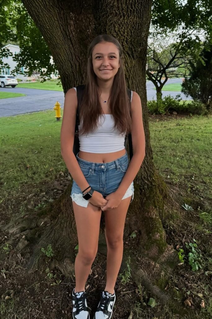  White Cropped Tank Top + Light Wash Denim Shorts + Black and White High-Top Sneakers