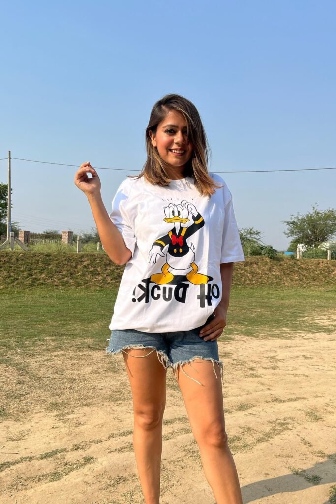 White Donald Duck Graphic T-shirt + Distressed Denim Shorts + (Footwear not visible)