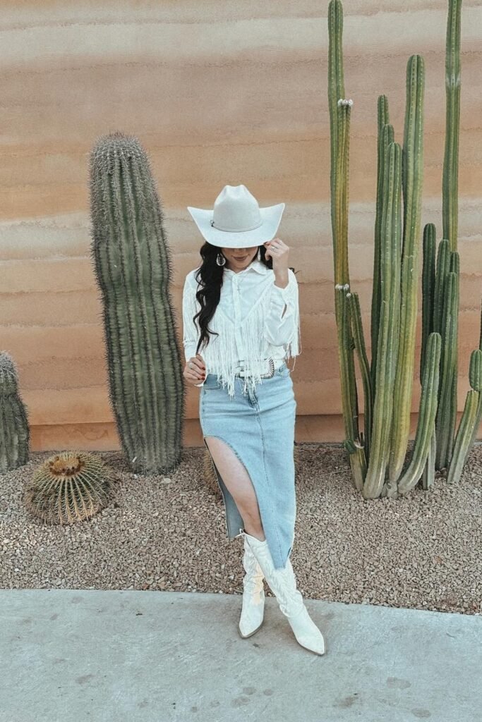 White Fringed Button-Down Shirt + Light Wash Denim Maxi Skirt with Slit + White Patterned Cowboy Boots + White Cowboy Hat