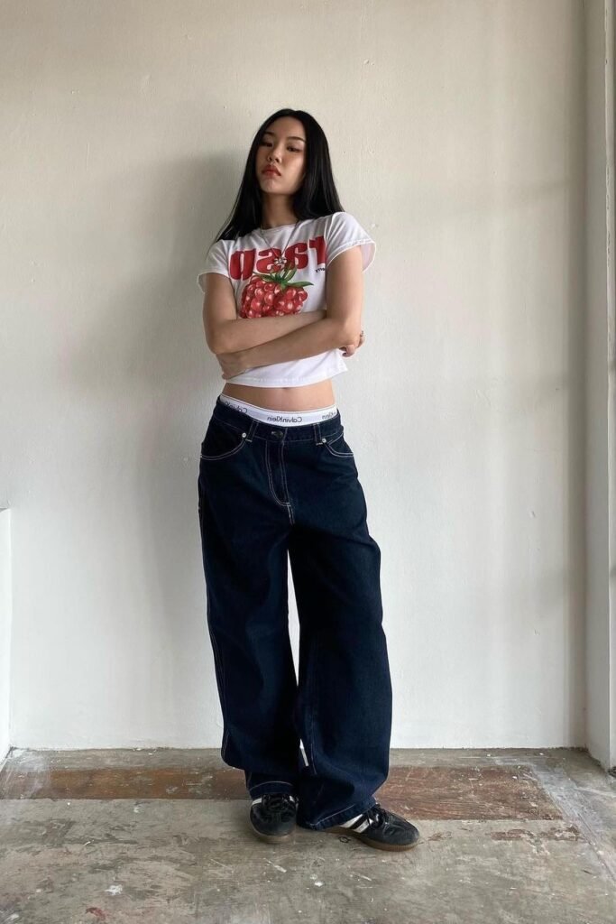 White Graphic Baby Tee + Oversized Dark Wash Carpenter Jeans + Black Sneakers