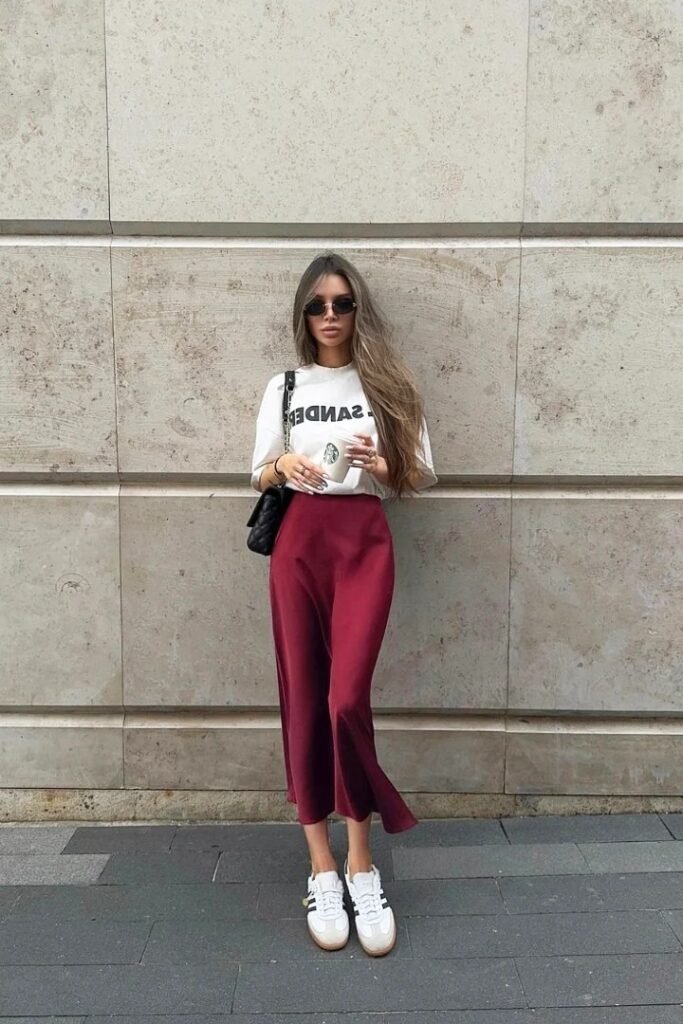 White Graphic T-Shirt + Burgundy Satin Slip Skirt + White Adidas Samba Sneakers