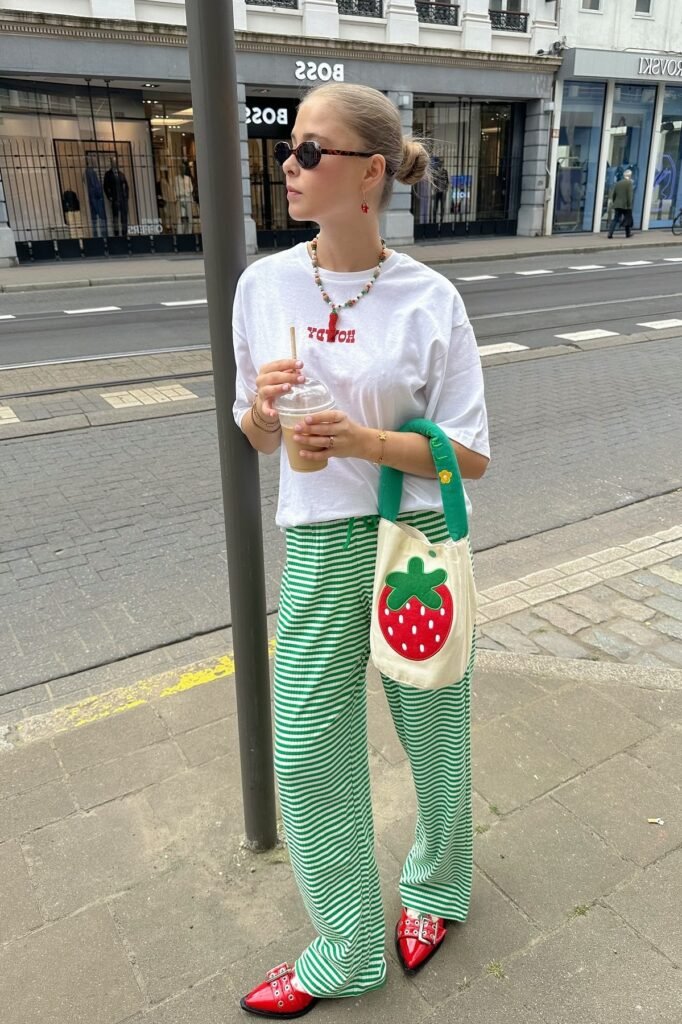 White Graphic T-shirt + Green and White Striped Flare Pants + Red Pointed-Toe Buckle Shoes
