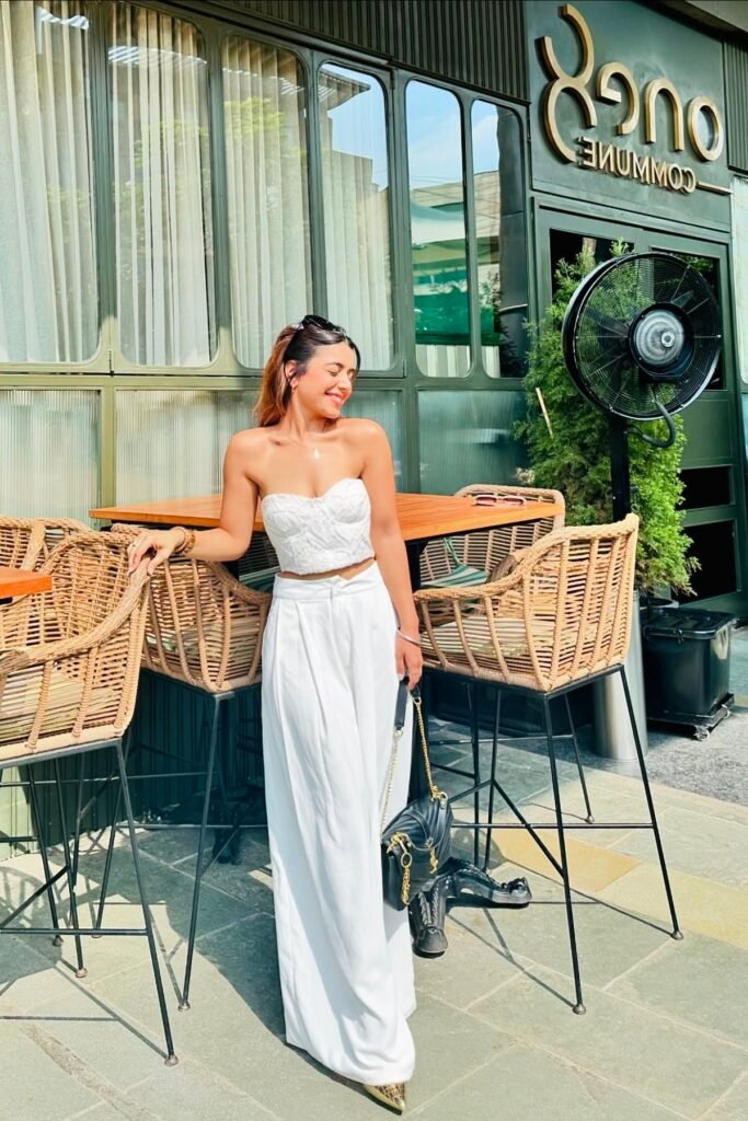 White Lace Bustier Crop Top + White Wide-Leg Trousers + Black Quilted Chain Bag + Gold Pointed Heels