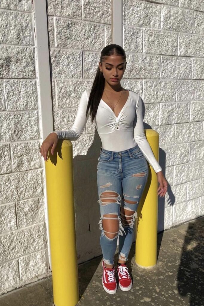 White Long-Sleeve Twisted Bodysuit + Ripped Skinny Jeans + Red Vans Sneakers