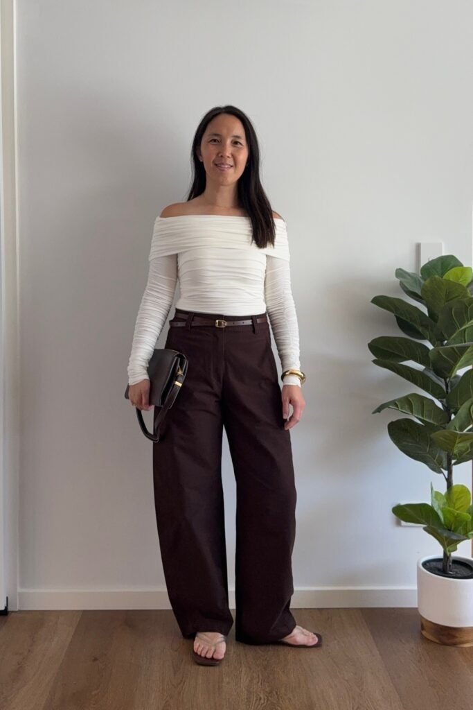 White Off-the-Shoulder Long-Sleeve Top + Dark Brown Wide-Leg Trousers + Beige Thong Sandals