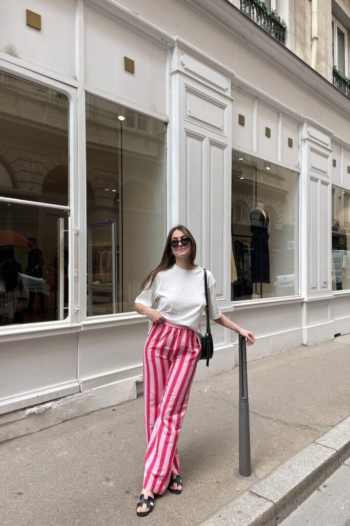 White Oversized T-Shirt + Pink and Red Vertical Striped Trousers + Black H-Strap Slide Sandals