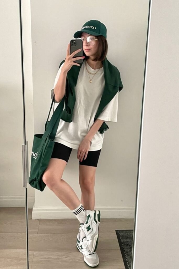 White Oversized T-shirt + Black Biker Shorts + White and Green Sneakers