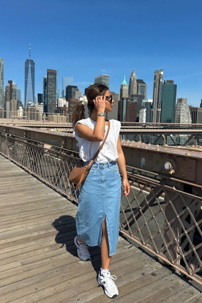 White Padded Shoulder Tee + Light Wash Denim Midi Skirt + White Athletic Sneakers