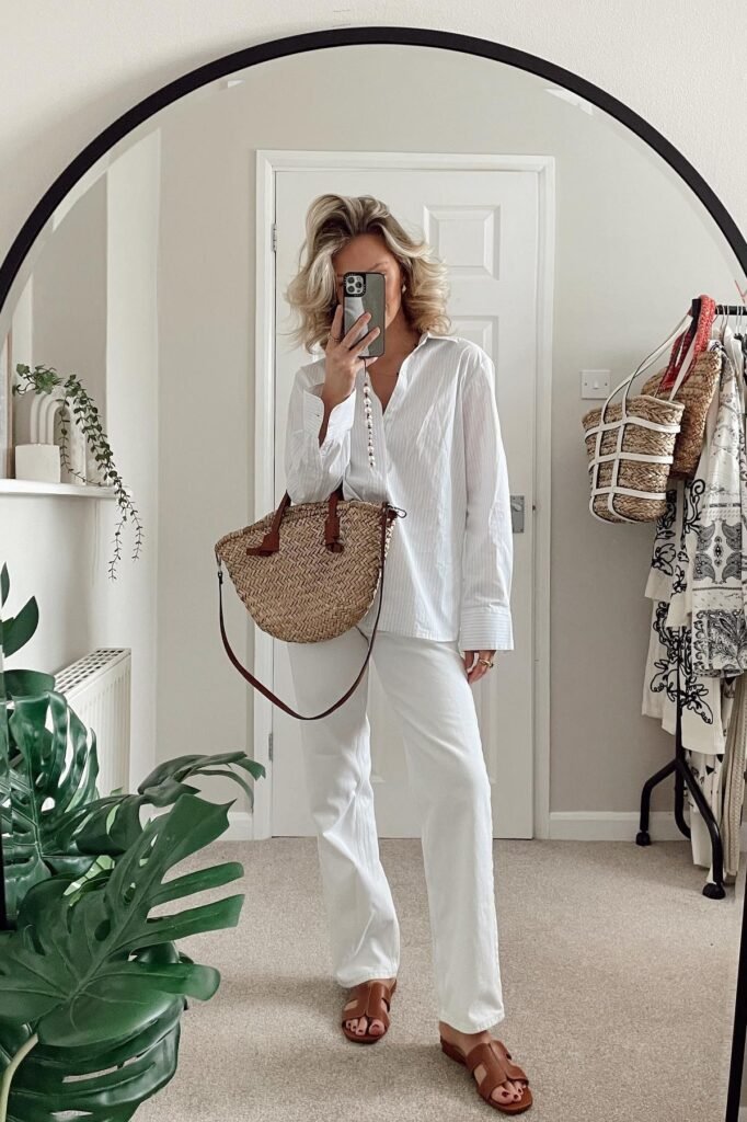 White Pinstripe Button-Down Shirt + White Straight-Leg Jeans + Brown Leather Slide Sandals