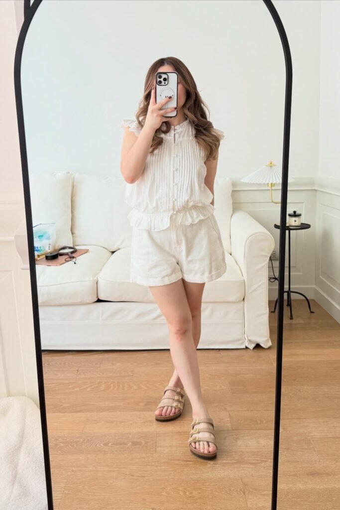 White Pleated Sleeveless Blouse + White High-Waisted Shorts + Tan Triple-Strap Sandals