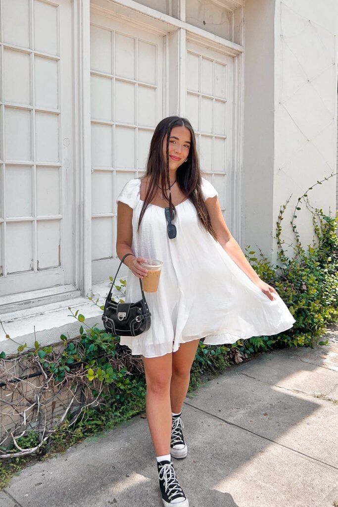 White Puff-Sleeve Baby Doll Dress + Black High-Top Sneakers + Black Buckled Handbag