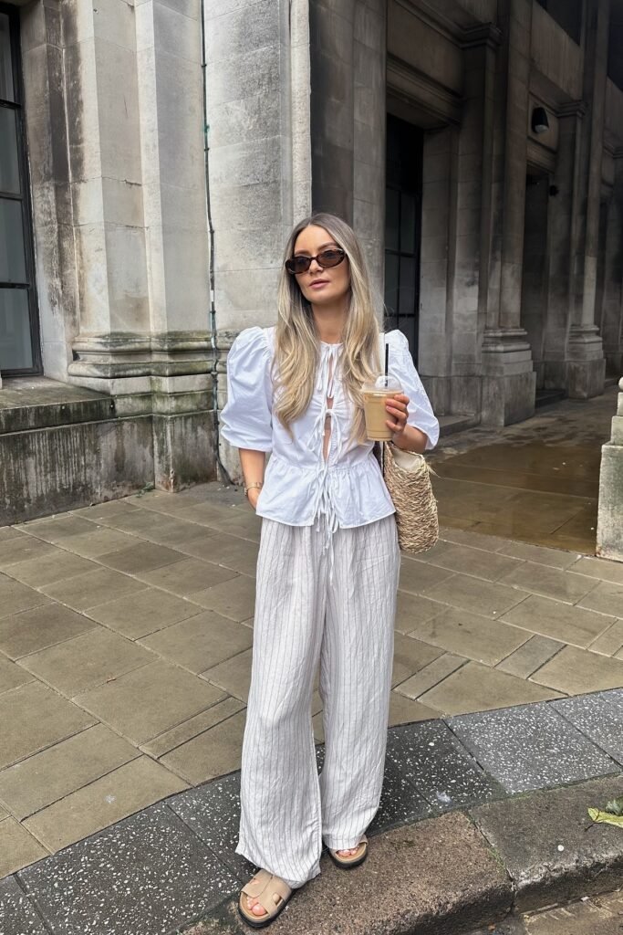 White Puff-Sleeve Tie-Front Blouse + Grey Pinstripe Wide-Leg Pants + Beige Slide Sandals
