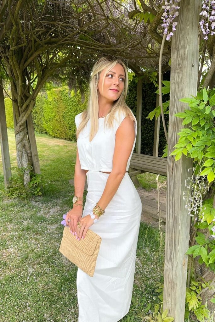 White Sleeveless Cut-Out Maxi Dress + Straw Clutch + Gold Accessories