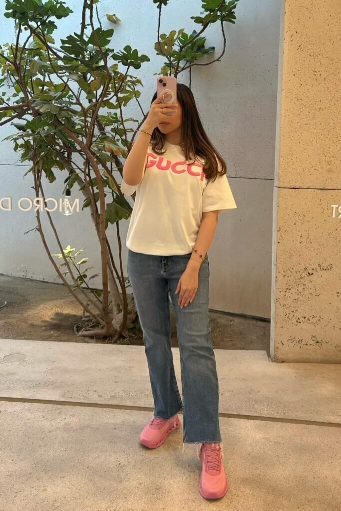 White T-shirt with Pink Logo + Classic Blue Straight-Leg Jeans + Bright Pink Athletic Sneakers