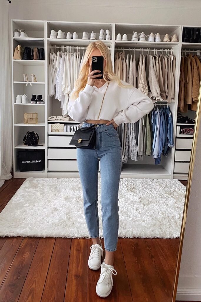 White V-Neck Cropped Sweatshirt + Light Wash Skinny Jeans + White Sneakers