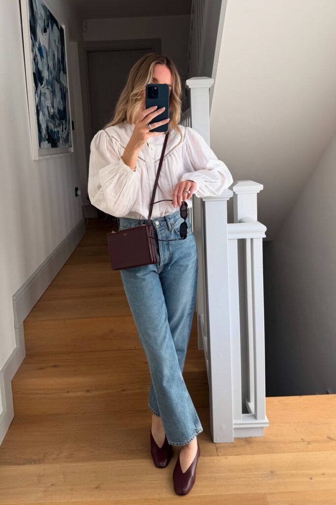 White Victorian-Style Puff Sleeve Blouse + Light Wash Straight-Leg Jeans + Burgundy Crossbody Bag + Burgundy Square-Toe Flats