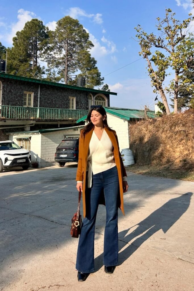 White Wrap Sweater + Cognac Long Coat + Dark Wash Flare Jeans + Black Square-Toe Boots