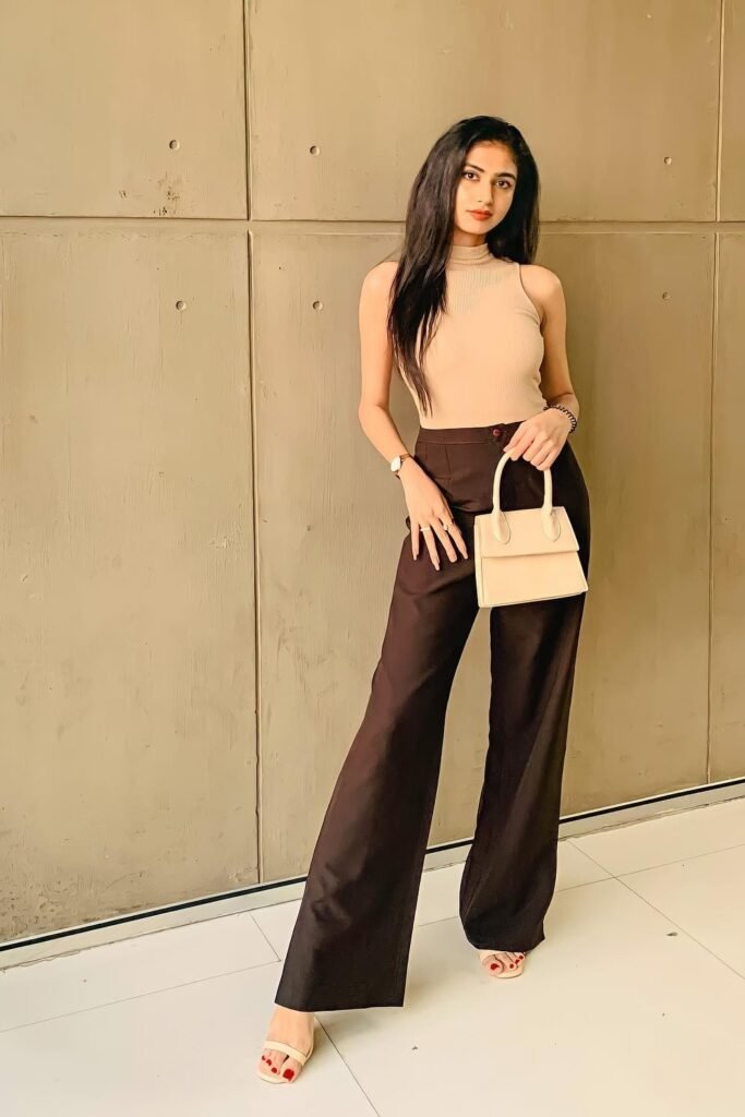 Beige Sleeveless Turtleneck Top + Dark Brown Wide-Leg Trousers + Cream Mini Handbag + Beige Strappy Sandals