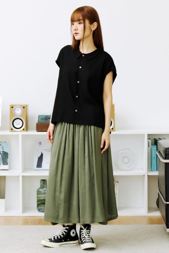 Black Cap-Sleeve Button-Up Shirt + Olive Green Maxi Pleated Skirt + Black High-Top Sneakers