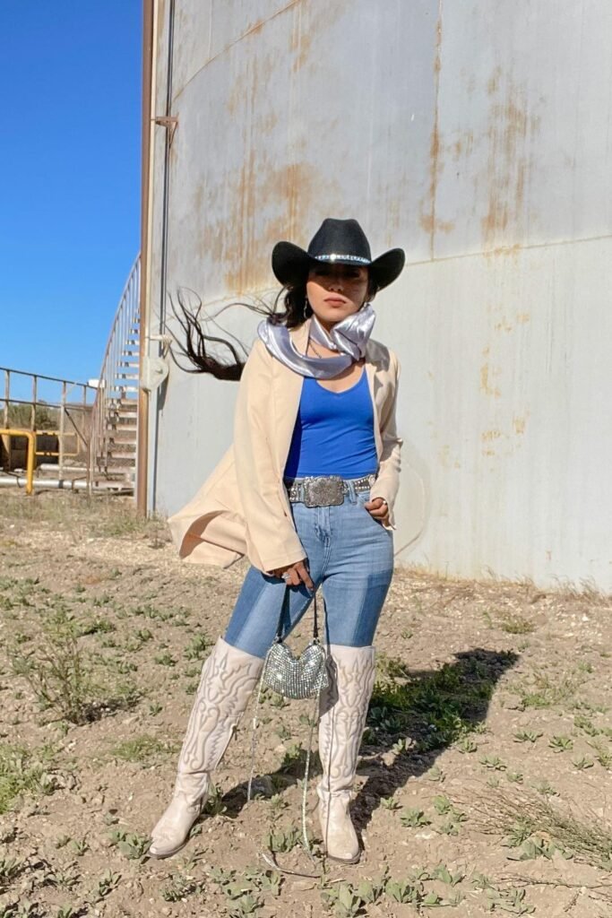 Black Cowboy Hat + Beige Oversized Blazer + Blue Bodysuit + Light Wash Skinny Jeans + White Tall Western Boots