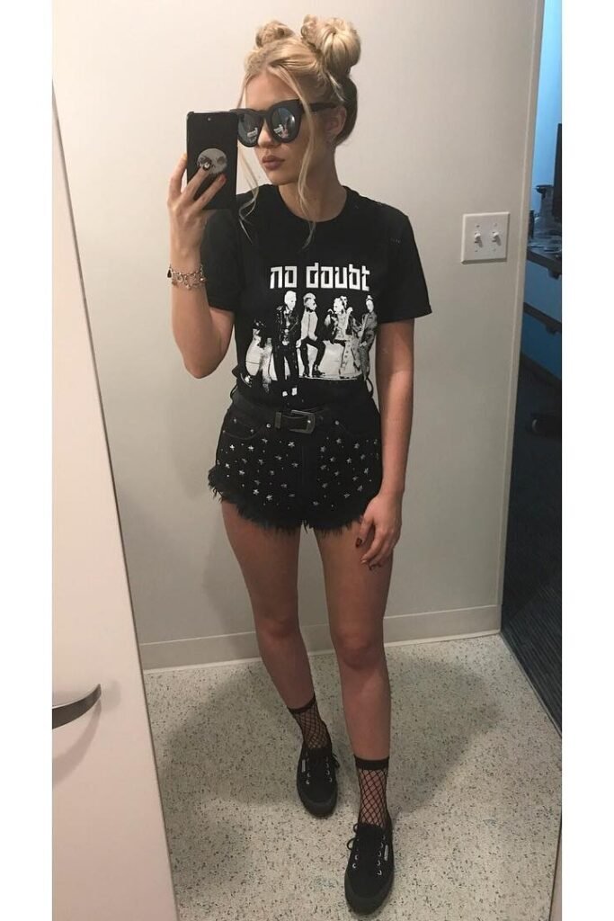 Black Graphic T-Shirt + Black Star-Studded Denim Shorts + Black Sneakers with Fishnet Socks