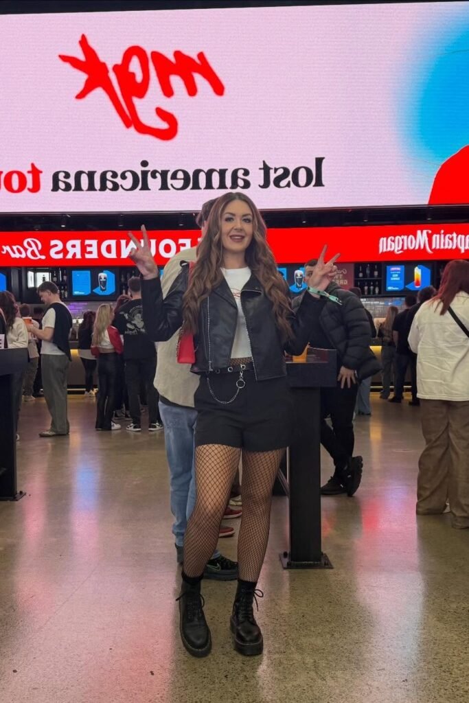Black Leather Biker Jacket + White T-Shirt + Black Shorts with Fishnet Tights
