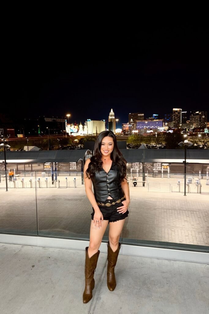 Black Leather Vest + Black Denim Shorts + Gold Chain Belt + Brown Leather Boots