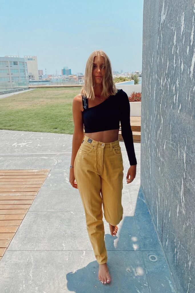 Black One-Shoulder Long-Sleeve Crop Top + Mustard Yellow Jeans