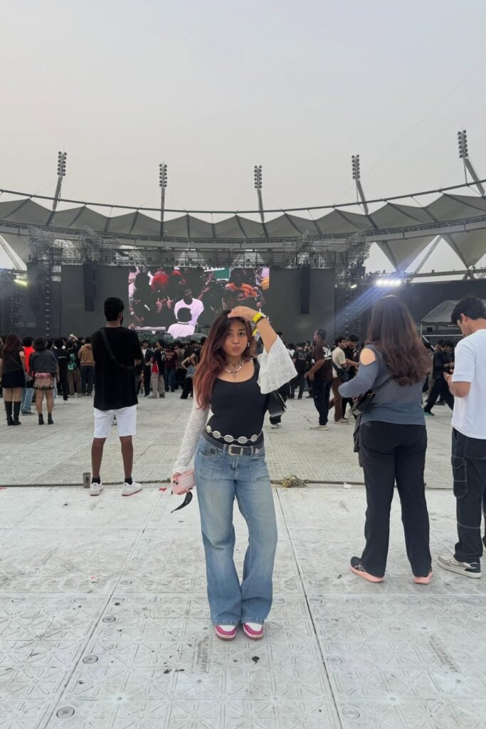 Black Scoop Neck Top with Lace Sleeves + Baggy Blue Jeans + Pink and White Sneakers