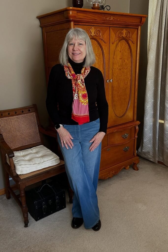 Black Turtleneck + Patterned Scarf + Wide-Leg Blue Jeans + Black Boots