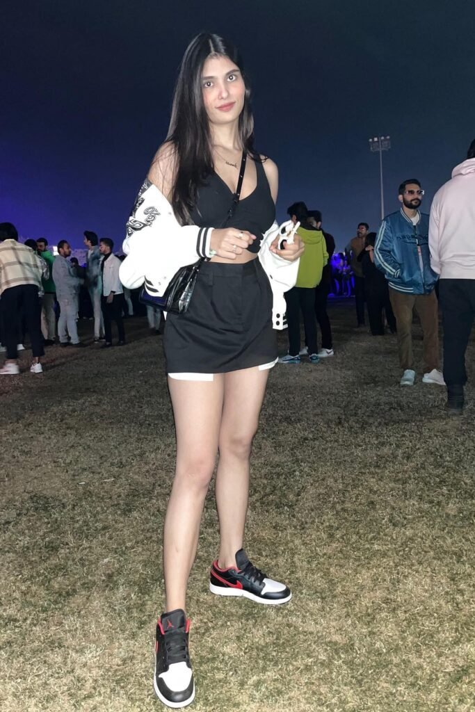 Black V-Neck Crop Top + Black Mini Skirt + White Varsity Jacket + Black and White Sneakers