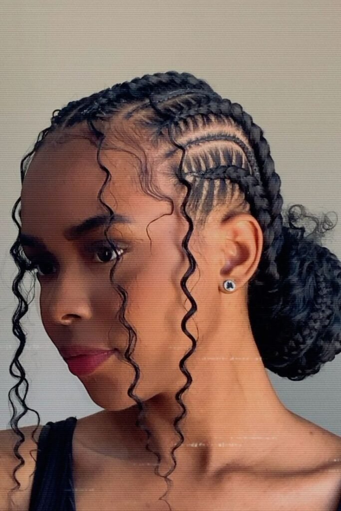 Curved Cornrows Collected into a Voluminous Low Braided Bun